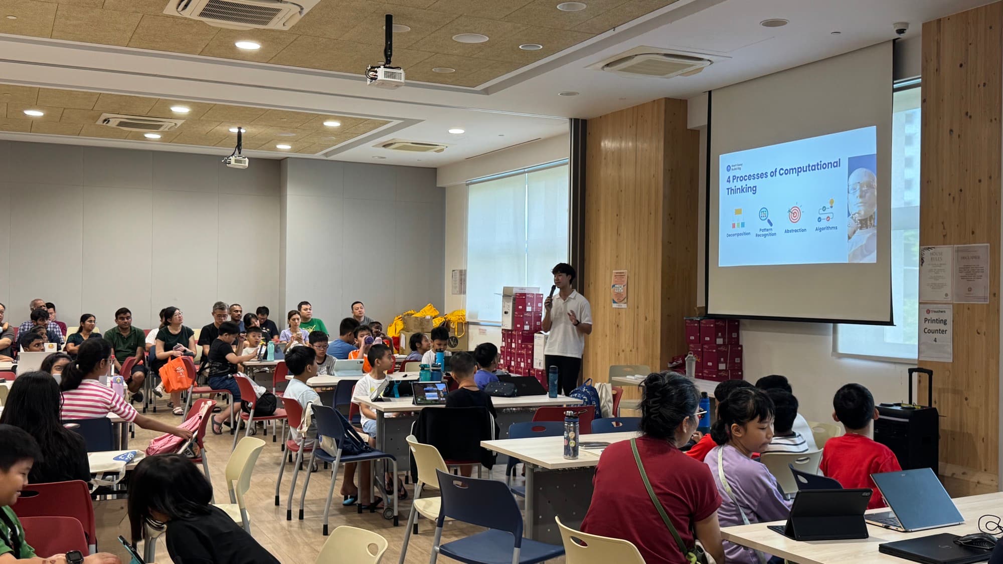 Codeezy facilitator leading a community coding and AI session in a Singapore community space